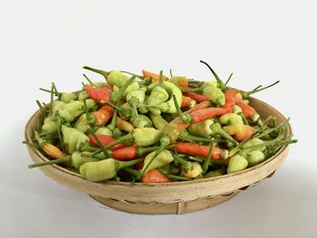 Close-up of vegetables in bowl against white background