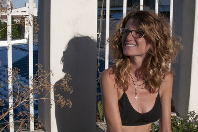 Portrait of young woman standing against sky