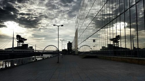 Bridge against cloudy sky