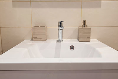 Bathroom interior with sink and faucet in apartment