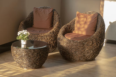 Close-up of potted plants in basket on table at home