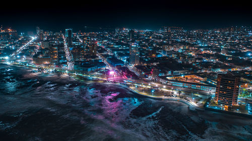 High angle view of illuminated buildings in city at night