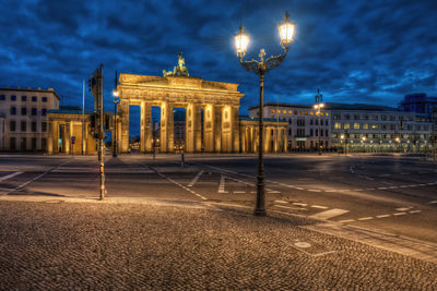 Statue in city at night