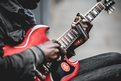 Close-up of man playing guitar