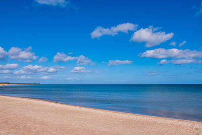 Scenic view of sea against blue sky