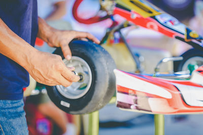 Close-up of man working on motorcycle