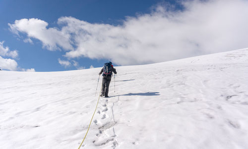 Full length of person on snowcapped mountain against sky