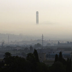 Silhouette cityscape against sky