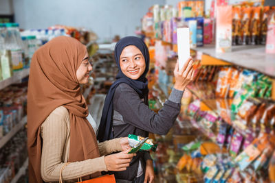 Portrait of young woman standing in store