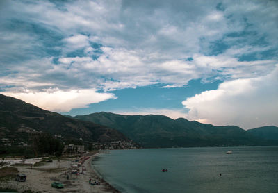 Scenic view of sea and mountains against sky