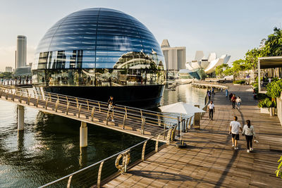 Rear view of people walking on footbridge