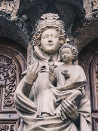 Low angle view of statue against historic building