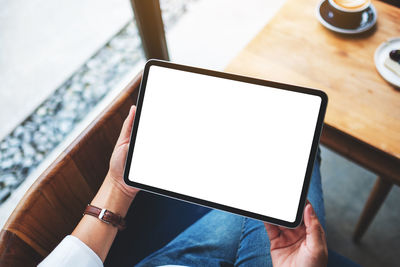 Midsection of woman using digital tablet