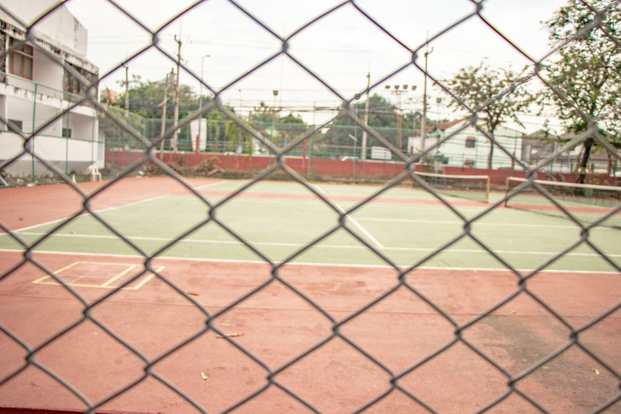 SCENIC VIEW OF FIELD SEEN THROUGH FENCE