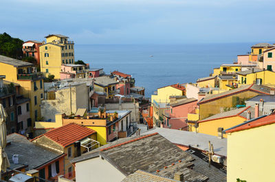 High angle view of town by sea against sky