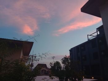 Low angle view of buildings against sky at sunset