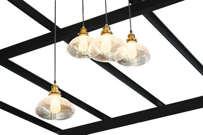 Low angle view of illuminated light bulb hanging on ceiling