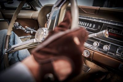 Midsection of man sitting in vintage car