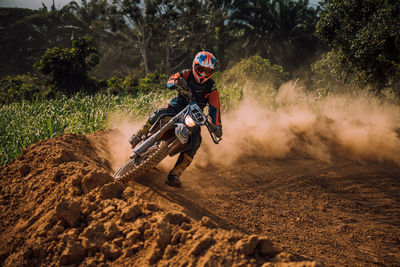 Man riding motorcycle on mud