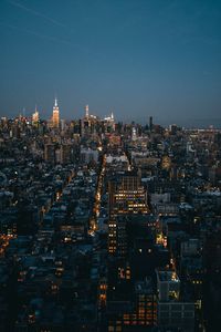 Aerial view of city lit up at night