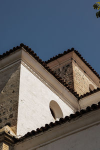 Low angle view of building against clear blue sky