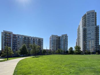 Buildings in city against clear blue sky