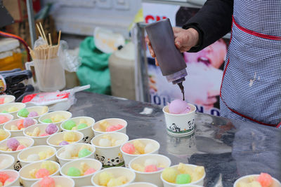 Closeup of ice cream cups with colorful cakes in the market in vietnam