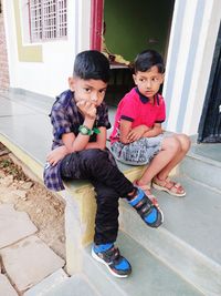 Portrait of happy friends sitting outdoors