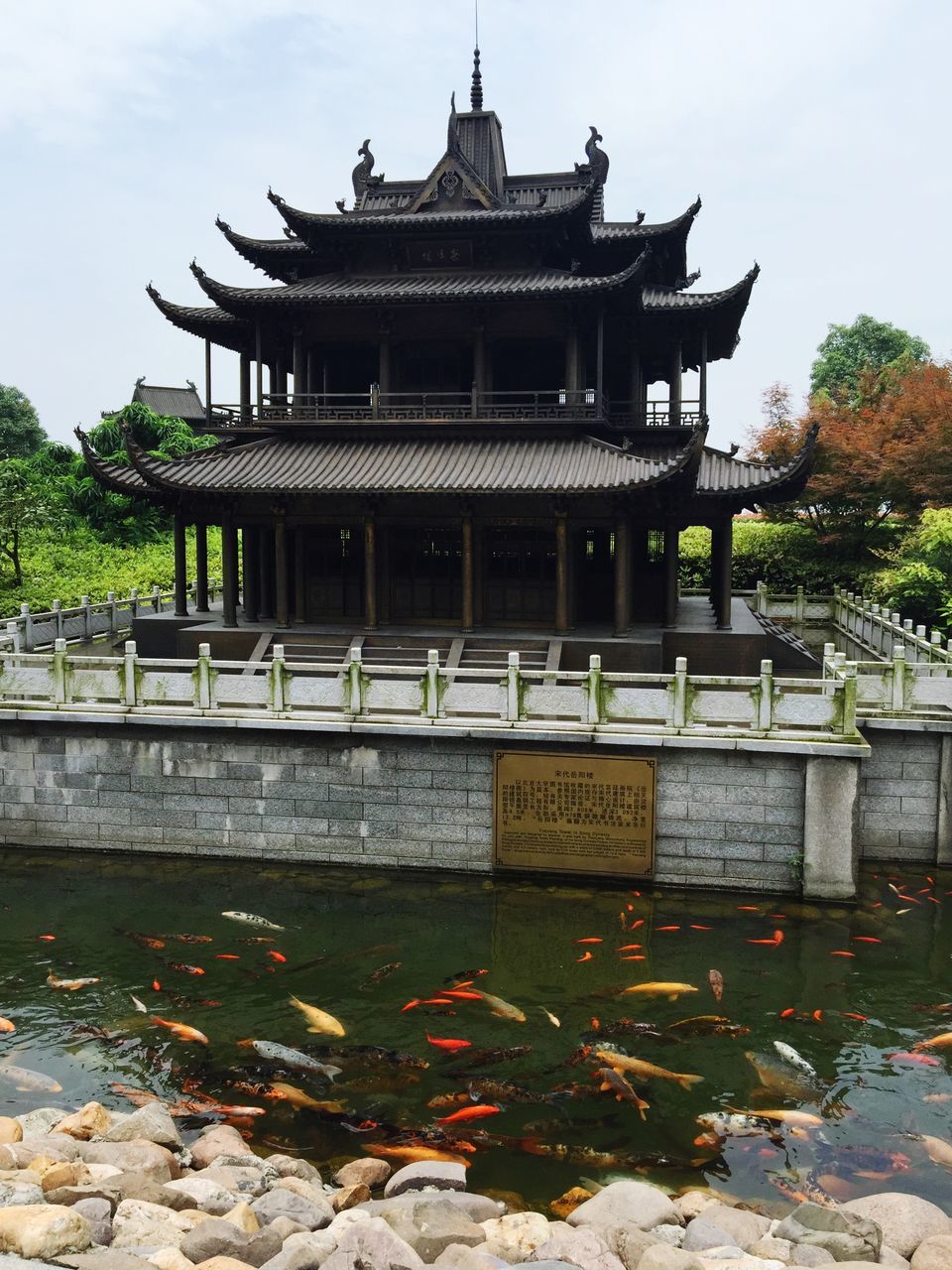 built structure, architecture, building exterior, temple - building, tree, religion, place of worship, famous place, spirituality, history, travel destinations, clear sky, sky, tourism, temple, travel, sculpture, outdoors, steps