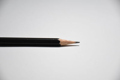 Close-up of pencils against white background