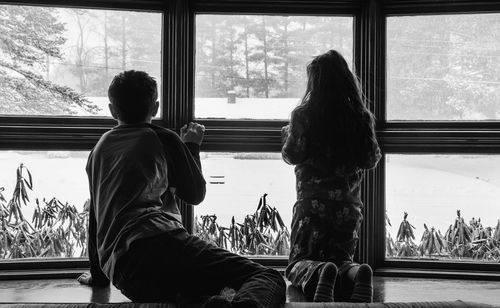 Children looking through window