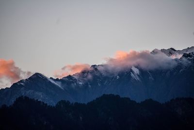 Scenic view of snowcapped mountains against sky during sunset