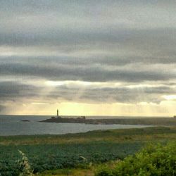 Scenic view of sea against cloudy sky