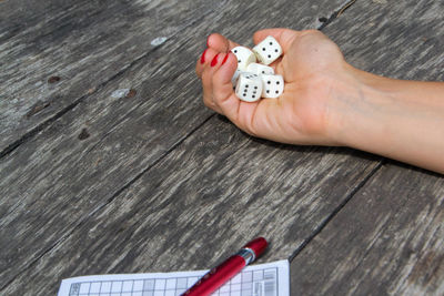 High angle view of baby playing with ball on table