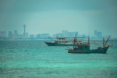 Scenic view of sea against sky in city