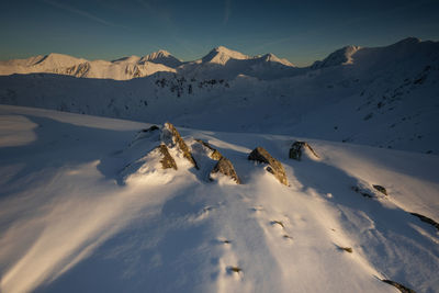 Scenic view of snow covered mountains against sky