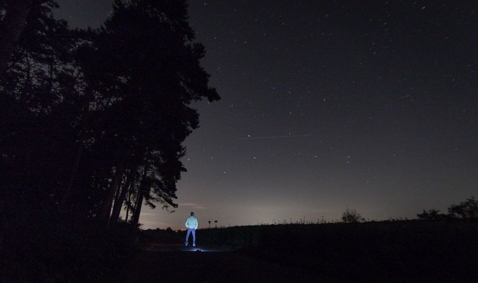 SILHOUETTE OF PERSON STANDING ON FIELD AGAINST CLEAR SKY