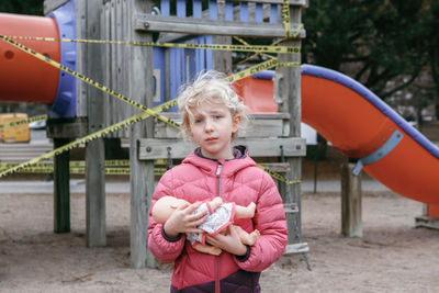 Portrait of cute girl holding playground