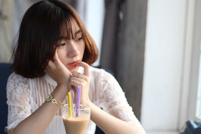 Young woman drinking glass