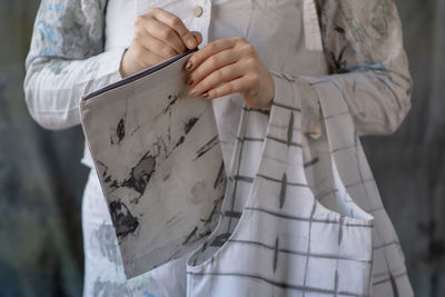 Midsection of woman holding umbrella