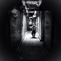 Full length rear view of people walking on walkway