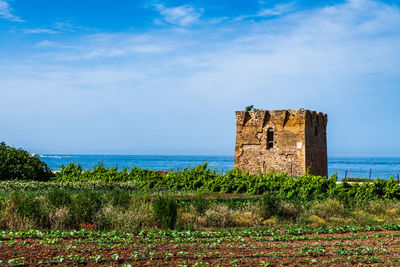 Castle by sea against sky