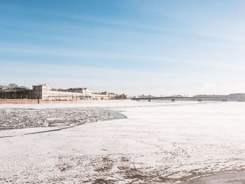 Scenic view of snow covered land against sky