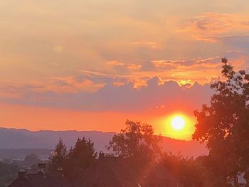 Scenic view of mountains against orange sky