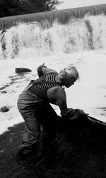 Side view of boy standing in water