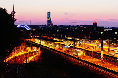 High angle view of illuminated railroad tracks against sky at sunset