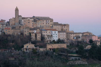 Buildings in town against clear sky