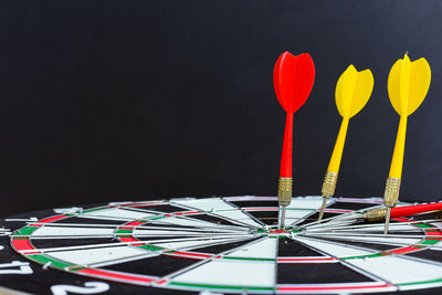 Close-up of multi colored umbrellas against black background