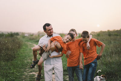 Happy fathers day. father with son are walking in the field.