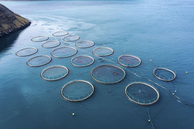 Salmon fish farm in ocean water near coast of streymay island